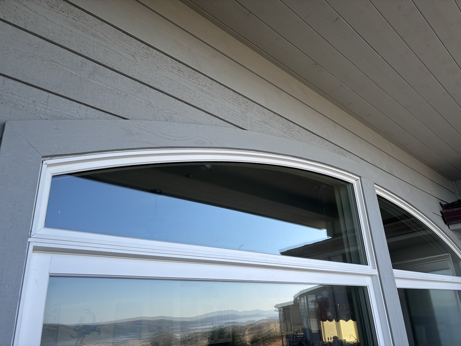 Close-up of the custom arched window assembly